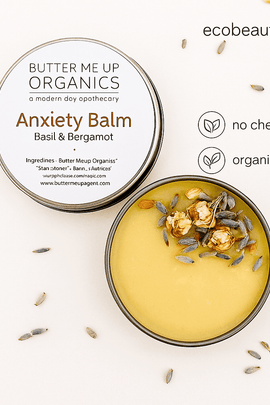 Butter Me Up Organics Anxiety Balm with basil and bergamot shown in open tin with dried herbs, marked ecobeaut.com, organic products, no chemicals – handcrafted anti-stress balm USA