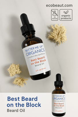 Butter Me Up Organics Best Beard On the Block beard oil bottle on marble surface with dried flowers – organic grooming product from ecobeaut.com