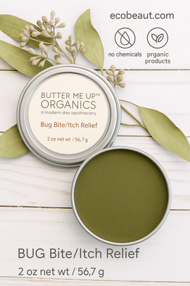 Butter Me Up Organics Bug Bite/Itch Relief balm tin displayed on a white wooden background with eucalyptus leaves, eco labels “no chemicals,” “organic products,” and ecobeaut.com in the top right corner.