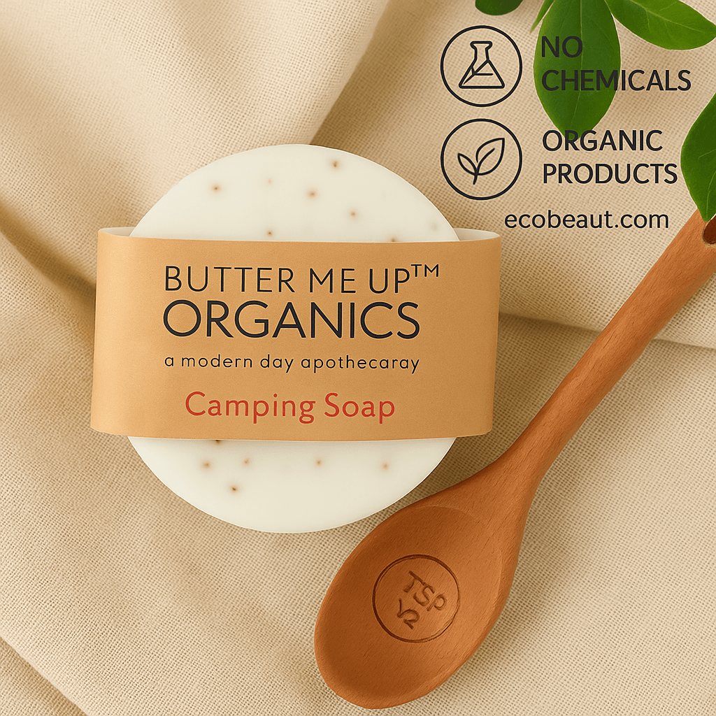 Butter Me Up Organics Camping Soap on beige fabric with green leaves and a wooden spoon, featuring “NO CHEMICALS,” “ORGANIC PRODUCTS” icons, and ecobeaut.com branding in the top right corner.
