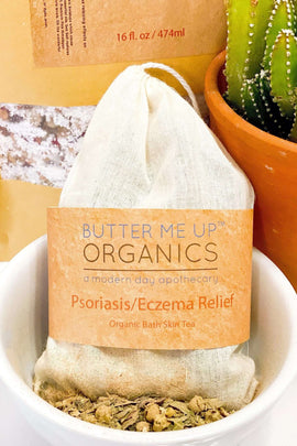 Butter Me Up Organics Psoriasis/Eczema Relief bath tea bag in a bowl with a cactus in the background