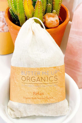 Butter Me Up Organics bath tea package with a cactus plant in the background