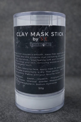 Clay mask stick with black label on a dark textured background