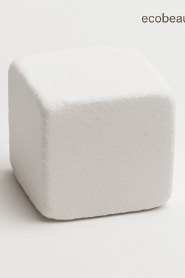 Close-up of a single white shower steamer cube with smooth surface on a light background, ecobeaut.com