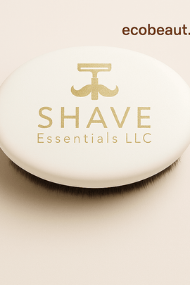 Close-up of white oval boar bristle shaving brush by SHAVE Essentials LLC with gold logo on a neutral background — ecobeaut.com