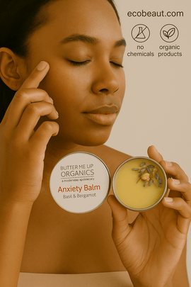 Dark-skinned woman applying Butter Me Up Organics Anxiety Balm with lavender and chamomile to her temple, labeled ecobeaut.com, no chemicals, organic products – natural calming balm USA
