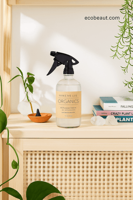 Dark-skinned woman holding organic all-purpose spray cleaner in a natural home setting – ecobeaut.com