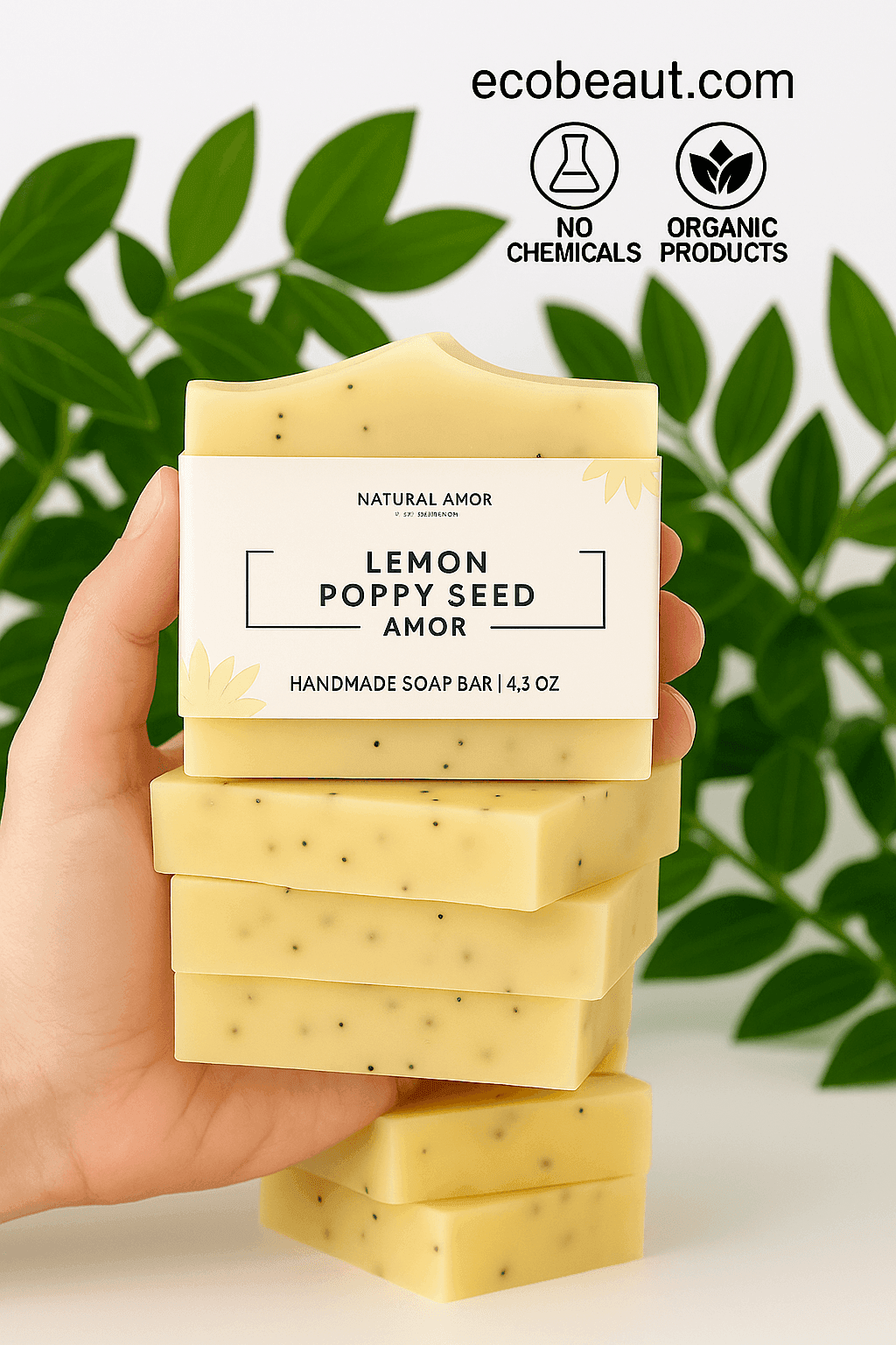 Hand holding Lemon Poppy Seed soap from Natural Amor with green leaves and eco labels