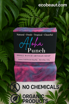 Handmade Aloha Punch artisan soap with colorful swirls, surrounded by tropical green leaves. Label features ecobeaut.com at the top and certifications for no chemicals and organic products at the bottom