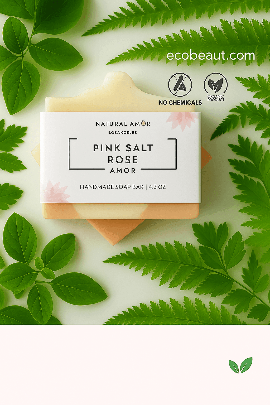 Handmade Pink Salt Rose soap bar by Natural Amor from ecobeaut.com, surrounded by fresh green leaves with “NO CHEMICALS” and “ORGANIC PRODUCT” icons in the upper right corner.