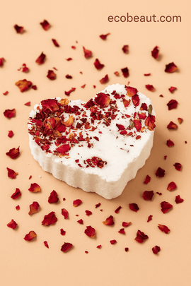 Heart-shaped organic rose bath bomb on white background with rose petals – handmade natural bath product ecobeaut.com