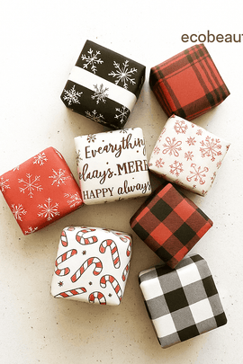 Holiday-themed peppermint stick bath bomb cubes arranged on a textured white surface with various gift wrap designs and ecobeaut.com in the corner
