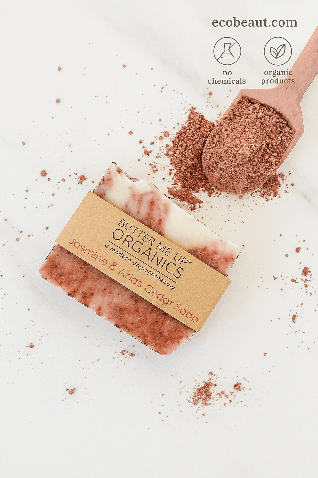 Jasmine & Atlas Cedar Soap by Butter Me Up Organics on a white marble background, surrounded by reddish powder, with ecobeaut.com, “NO CHEMICALS,” and “ORGANIC PRODUCTS” icons in the top right corner.