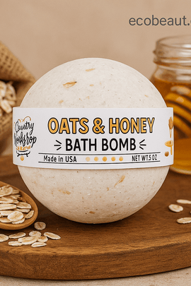Oats & Honey Bath Bomb on a wooden surface with raw oats and a jar of honey, labeled with ecobeaut.com and icons for organic and chemical-free care