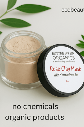 Open jar of Rose Clay Mask with Yarrow Powder by Butter Me Up Organics, surrounded by green leaves on a clean white background, with ecobeaut.com in the top right corner and labels 'no chemicals' and 'organic products' clearly visible