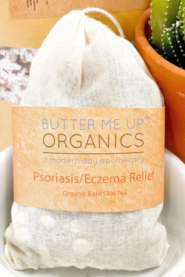 Bag of 'Butter Me Up Organics' Psoriasis/Eczema Relief bath skin tea with a cactus plant in the background.