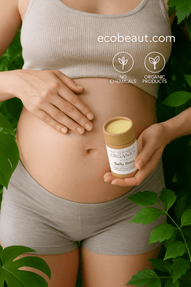 "Pregnant woman applying organic Belly Balm with lush green leaves, eco labels, and ecobeaut.com branding in the top right corner."