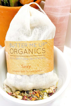 Butter Me Up Organics bath tea and soap in a white bowl with a cactus in the background