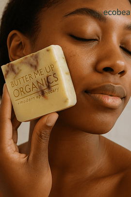 Young Black woman applying organic soap labeled Butter Me Up Organics to her face – no chemicals, organic products – ecobeaut.com