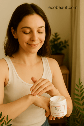 Young light-skinned woman smiling while applying Elegant Rose body cream to her forearm in a softly lit, natural setting, with ecobeaut.com text in the top right corner.