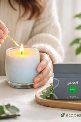 Person lighting a candle with a 'Sanari' product in the background on a table.