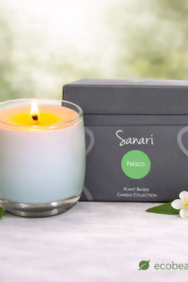 Sanari Fresco candle with packaging and decorative elements on a blurred natural background