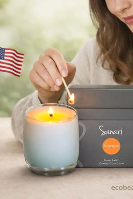 Woman lighting a candle with a match, next to a 'Sanari' candle box and an American flag.