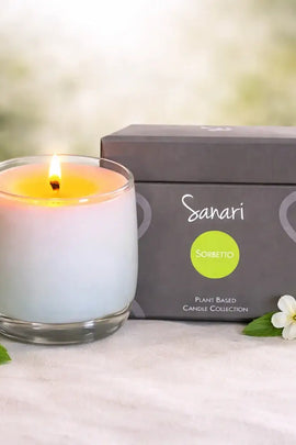 Sanari candle with packaging and decorative elements on a light surface