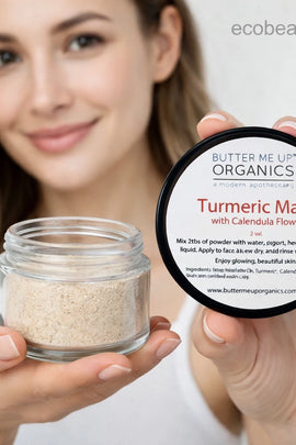Woman holding a jar and container of Butter Me Up Organics Turmeric Mask with Calendula Flowers.