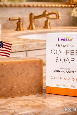 Bar of coffee soap with a box labeled 'fivess' on a bathroom counter.