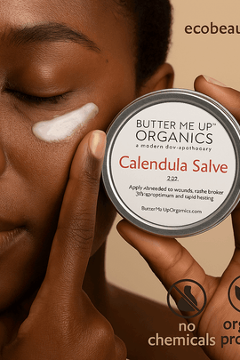 woman applying Calendula Salve under her eye, holding a tin of Butter Me Up Organics salve – ecobeaut.com, no chemicals, organic products