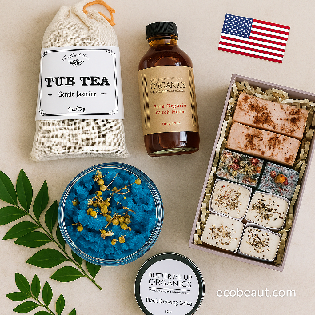 Flat lay of organic skincare products including tub tea, bath cubes, witch hazel, blue body scrub, and black drawing salve on a clean white surface, with a small American flag and ecobeaut.com logo in the corners.
