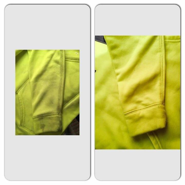 Close-up of a bright yellow jacket with a pocket detail on a white background.