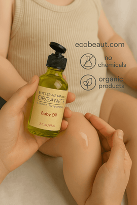 A caregiver applies Butter Me Up Organics Baby Oil to a baby's leg. The bottle is labeled clearly, and eco-labels with ecobeaut.com are shown in the top right corner.
