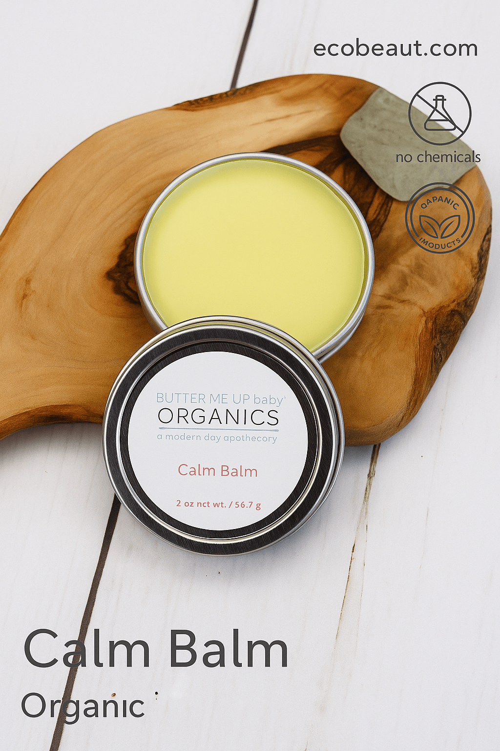 A tin of Butter Me Up Organics Calm Balm displayed on a wooden surface with its lid open, showing the smooth balm inside. The image includes eco-friendly labels "no chemicals" and "organic products" along with the website ecobeaut.com in the top right corner.




