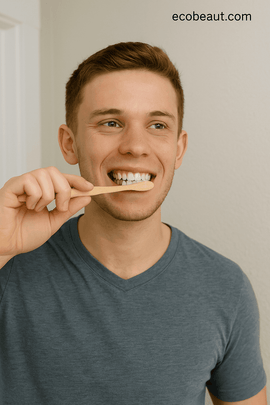 A young man using organic tooth powder in a natural bathroom setting – promoting eco-friendly oral care with ecobeaut.com branding in the top-right corner.