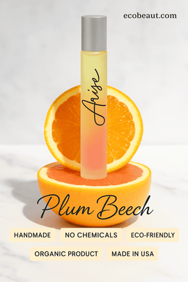 Arise Rollerball Perfume – Embrace Your Inner Light displayed with orange slices and eco-friendly labels