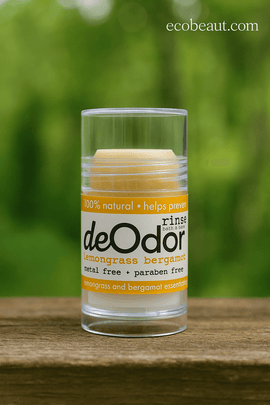 Natural lemongrass bergamot deodorant on wooden surface outdoors with green nature background, eco-friendly aluminum-free deodorant from ecobeaut.com made in USA