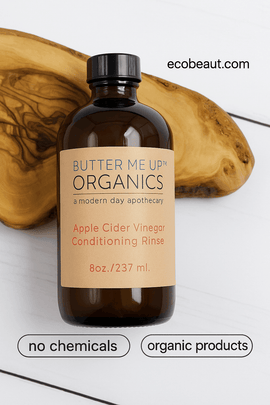 Butter Me Up Organics Apple Cider Vinegar Conditioning Rinse bottle on wood slice, with “no chemicals,” “organic products” icons at the bottom and ecobeaut.com in the top right corner.