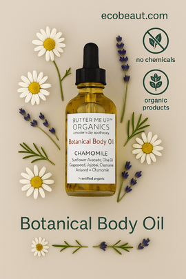 Butter Me Up Organics Chamomile Botanical Body Oil in a clear glass bottle with black dropper, surrounded by chamomile and lavender flowers on a soft beige background, featuring ecobeaut.com, no chemicals, and organic products icons in the top right corner