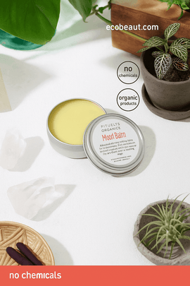 Butter Me Up Organics Moon Balm in open tin on a white surface with green plants and crystals – organic menstrual relief balm, no chemicals, ecobeaut.com