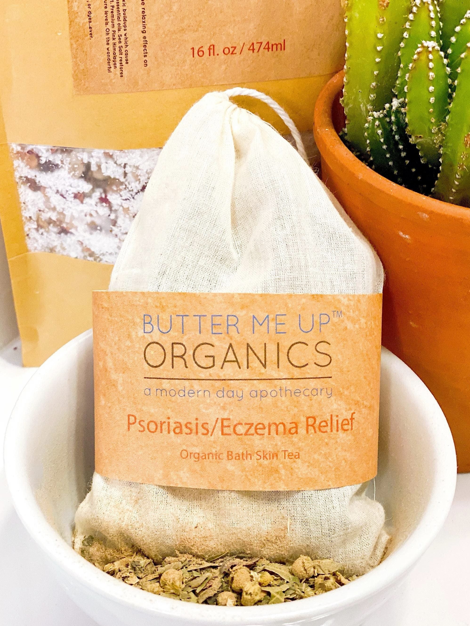 Butter Me Up Organics Psoriasis/Eczema Relief bath tea bag in a bowl with a cactus in the background