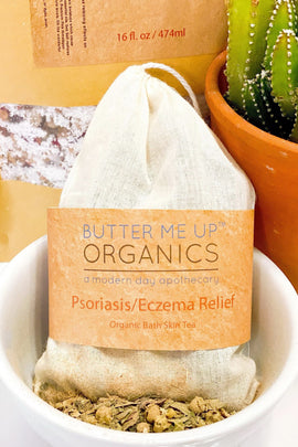 Butter Me Up Organics Psoriasis/Eczema Relief bath tea bag in a bowl with a cactus in the background