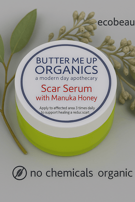 Butter Me Up Organics Scar Serum with Manuka Honey jar on a gray background, featuring ecobeaut.com in the top right and both “no chemicals” and “organic products” labels clearly shown at the bottom of the image.