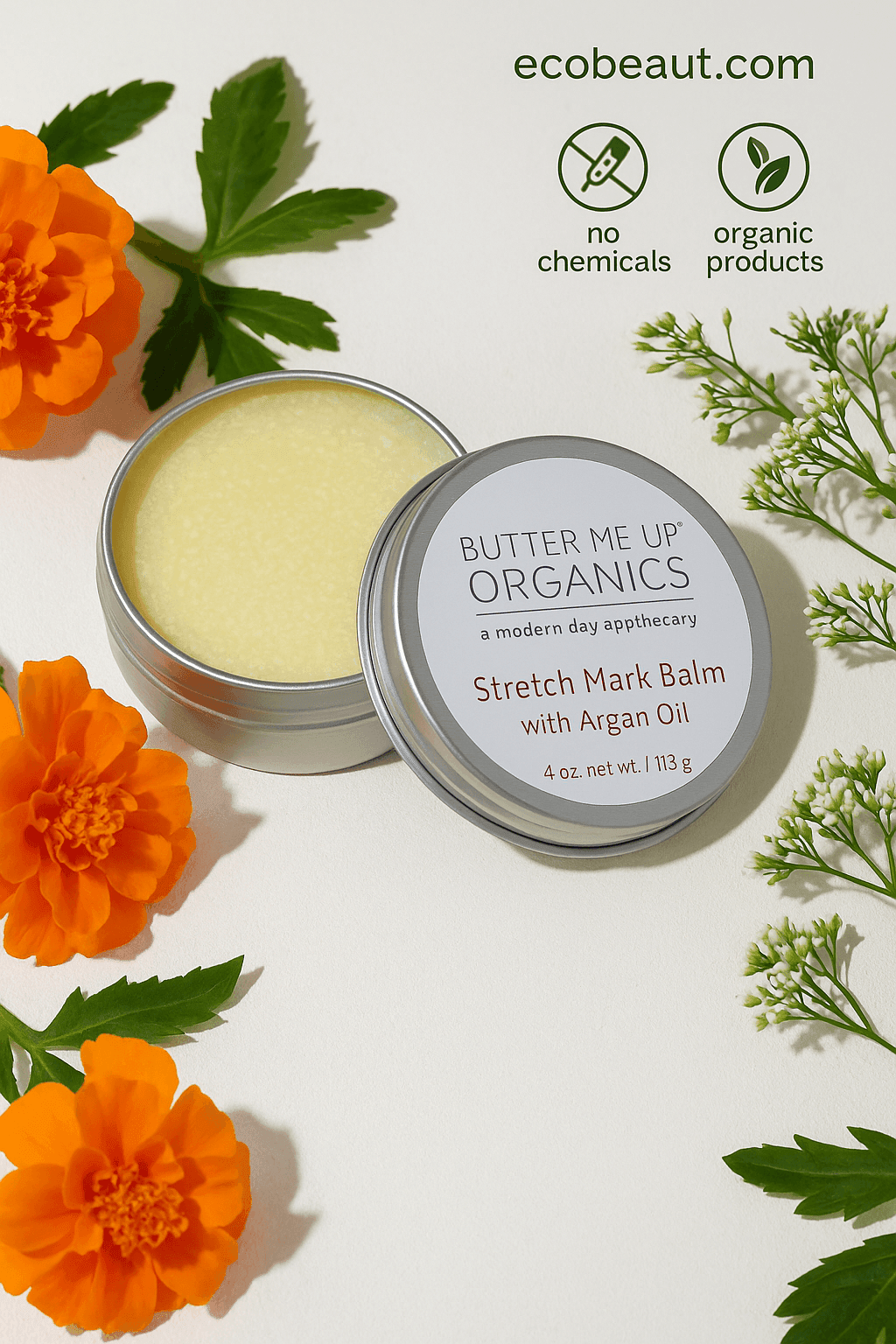 Butter Me Up Organics Stretch Mark Balm in a silver tin with the lid slightly open, surrounded by marigold and white flowers on a textured off-white surface, featuring no chemicals and organic products icons with ecobeaut.com in the top right corner








