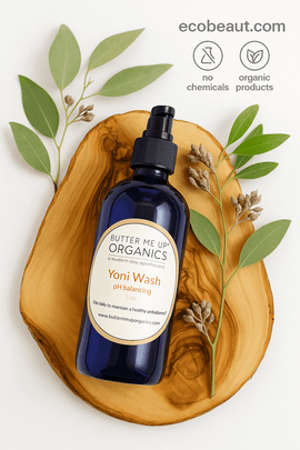  Butter Me Up Organics Yoni Wash bottle by ecobeaut.com on a wooden slab with green leaves, featuring “NO CHEMICALS” and “ORGANIC PRODUCTS” icons in the top right corner.