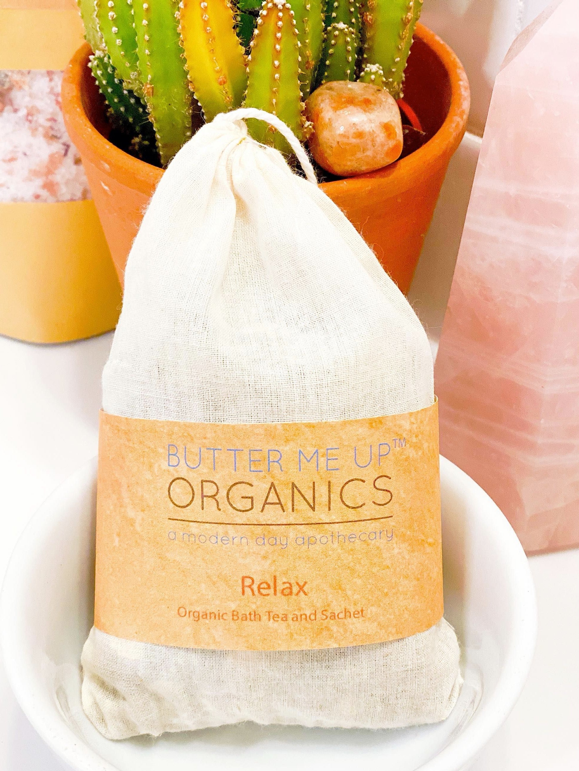 Butter Me Up Organics bath tea package with a cactus plant in the background