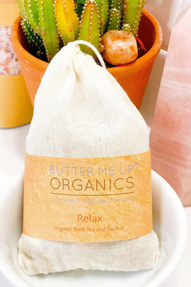 Butter Me Up Organics bath tea package with a cactus plant in the background