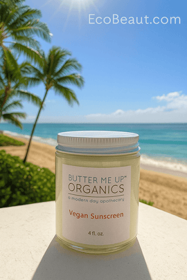 Butter Me Up Organics vegan sunscreen jar on tropical beach with palm trees, ocean waves, and bright sunshine, eco-friendly vegan sun care from EcoBeaut.com made in USA