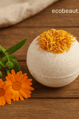 Calendula bath bomb with dried golden petals resting on a rustic wooden surface beside fresh calendula flowers, ecobeaut.com